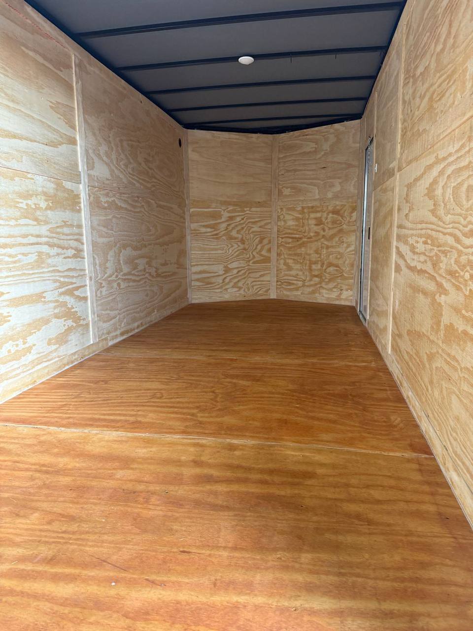 Plywood interior floor and walls inside blackout trim enclosed trailer